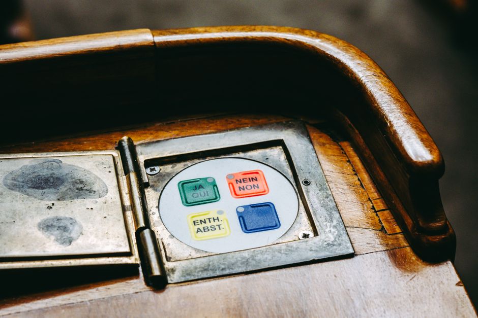 Wooden voting panel with multilingual buttons in Bern
